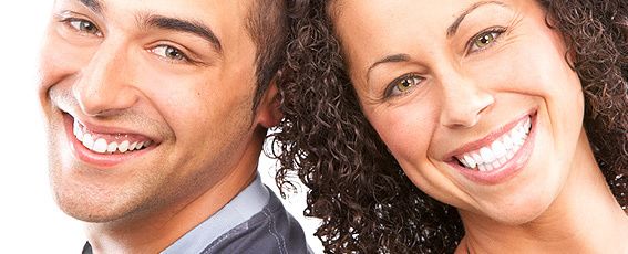 Headshot of two oral-maxillofacial surgery patients smiling